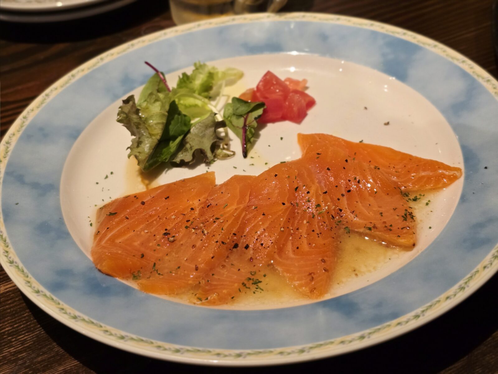 Salmon carpaccio with olive oil and herbs