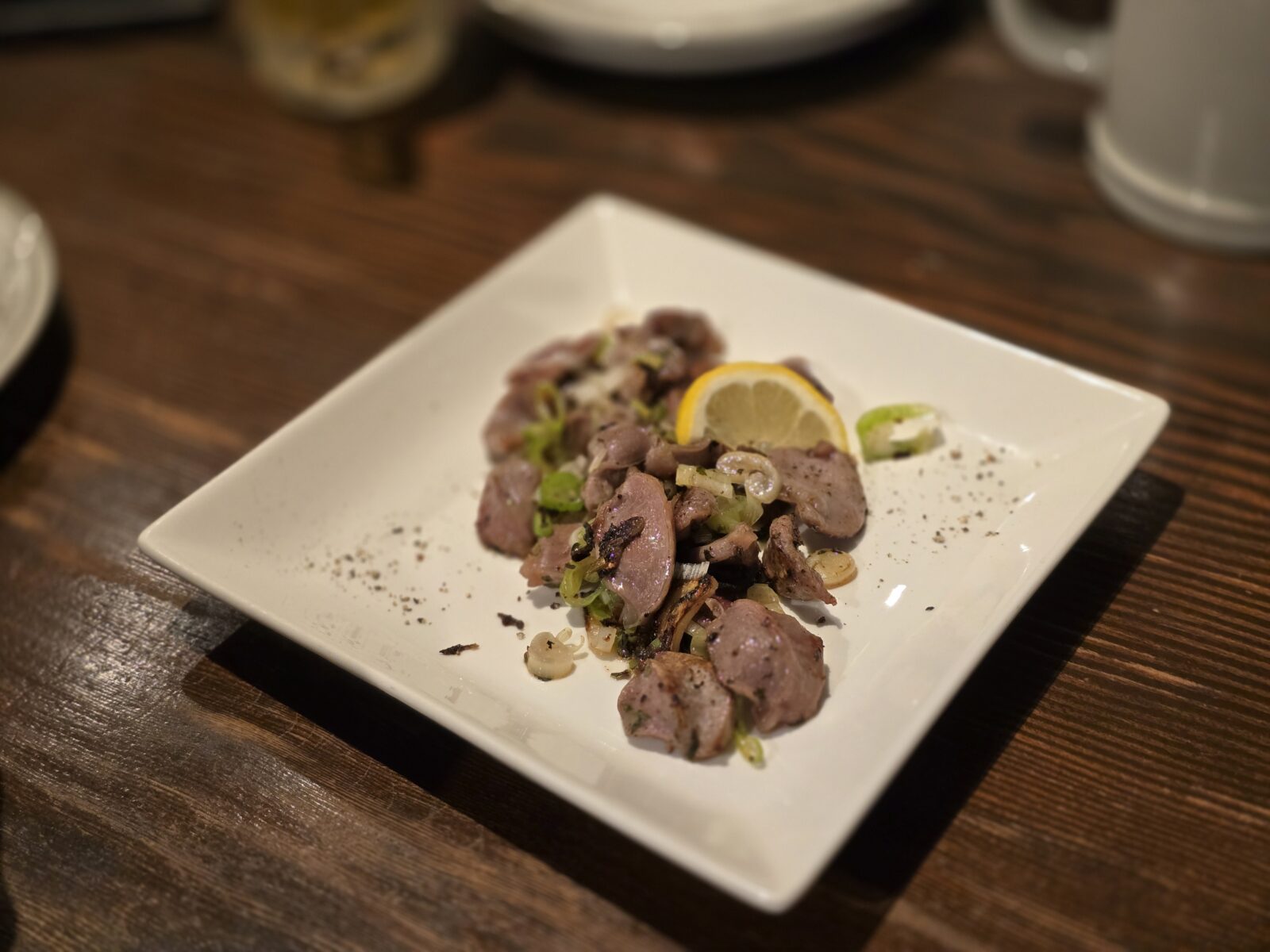 Grilled chicken gizzards with lemon and scallions at izakaya in Gifu