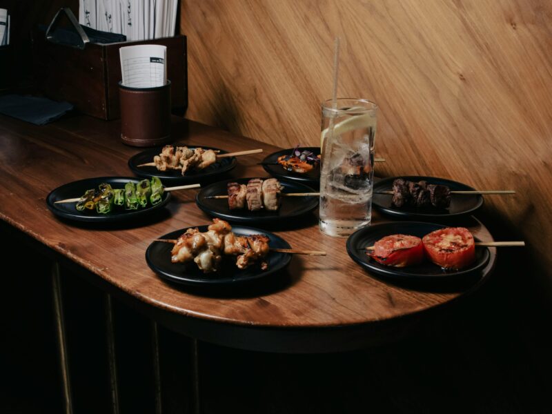 “Assorted yakitori skewers and drinks at a cozy izakaya in Japan