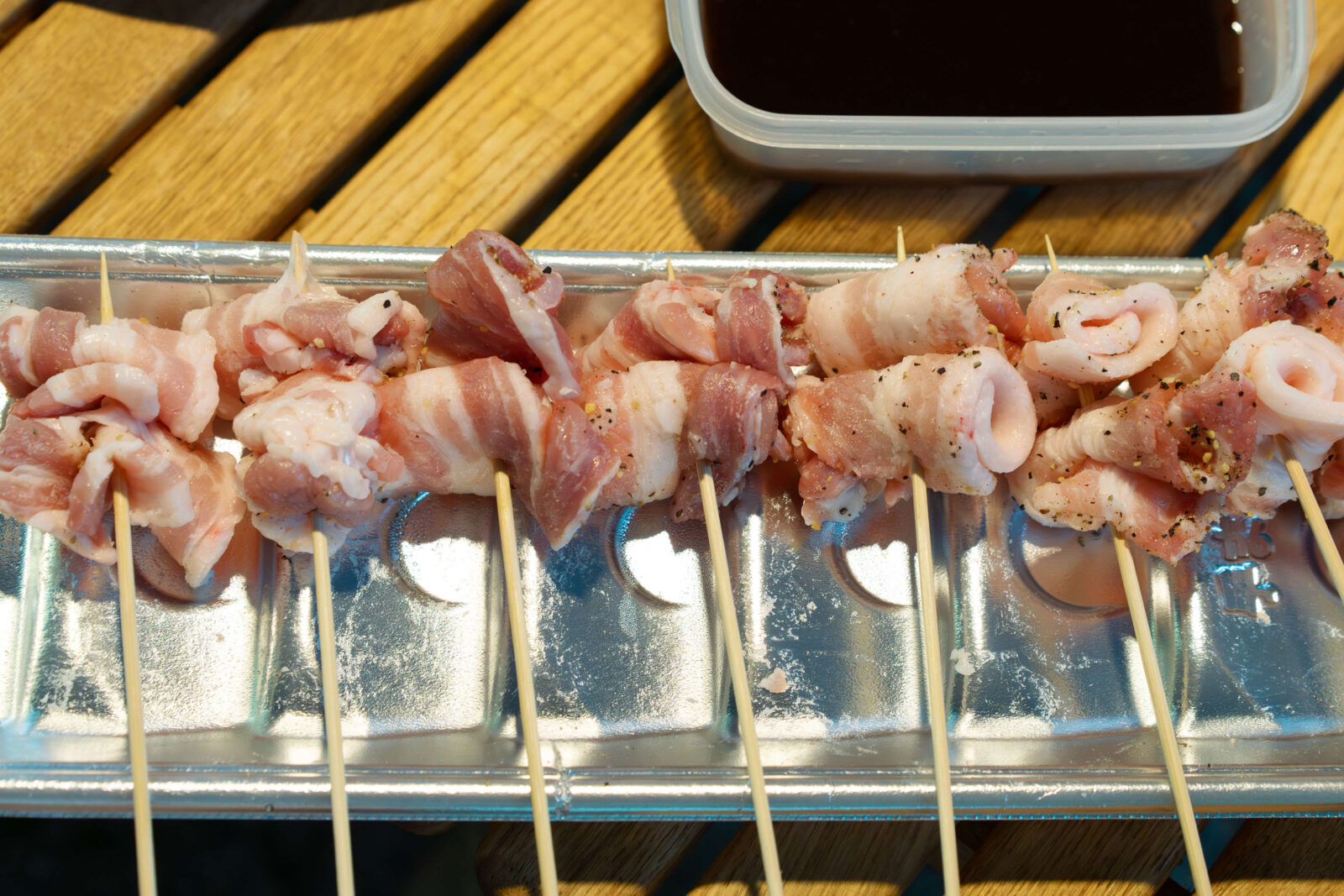 Uncooked pork belly skewers prepared for kushikatsu grilling at Pascal Kiyomi campsite