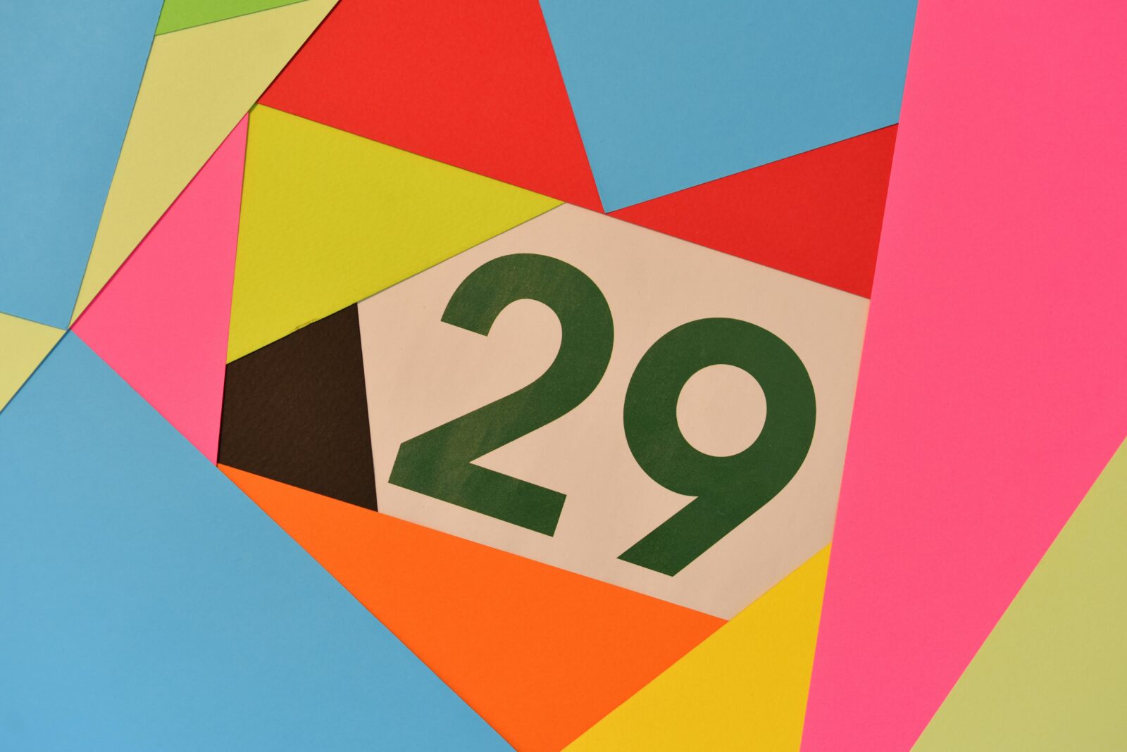 The number 29 displayed on a calendar-style design with colorful geometric paper background, representing Niku Day in Japan
